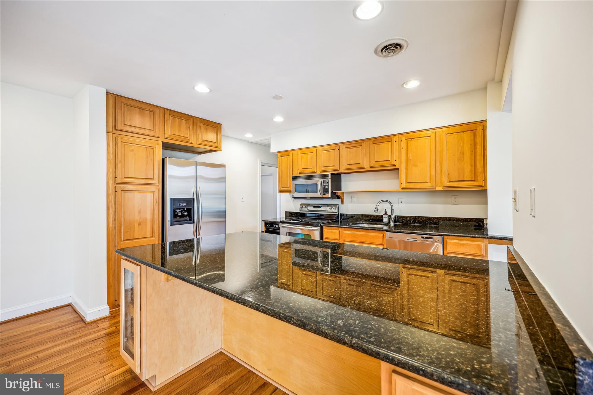 411 Pershing Drive Silver Spring, MD 20910 - Photo 16 of 64 a kitchen with stainless steel appliances granite countertop a sink and a refrigerator