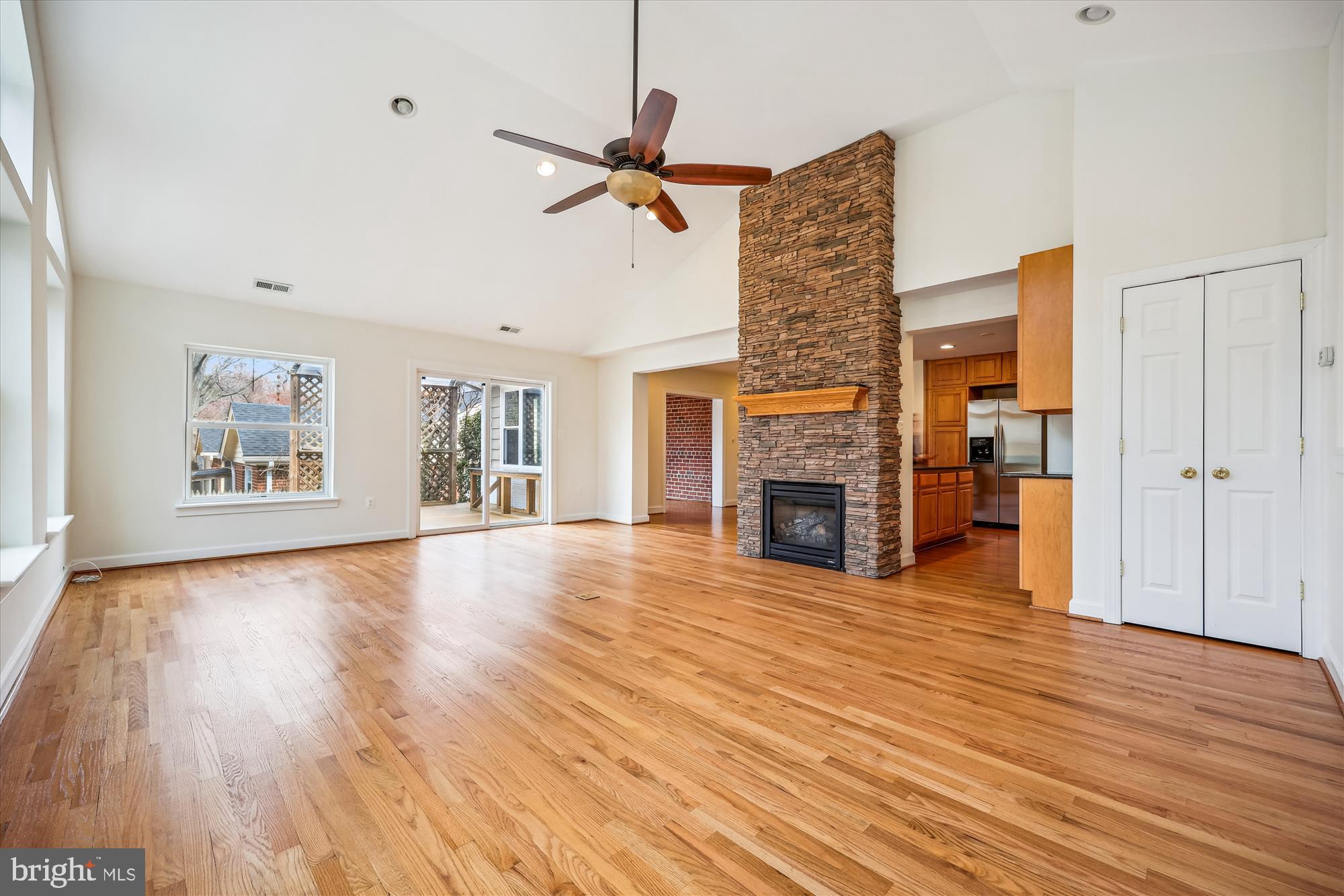 411 Pershing Drive Silver Spring, MD 20910 - Photo 27 of 64 an empty room with wooden floor fireplace and windows