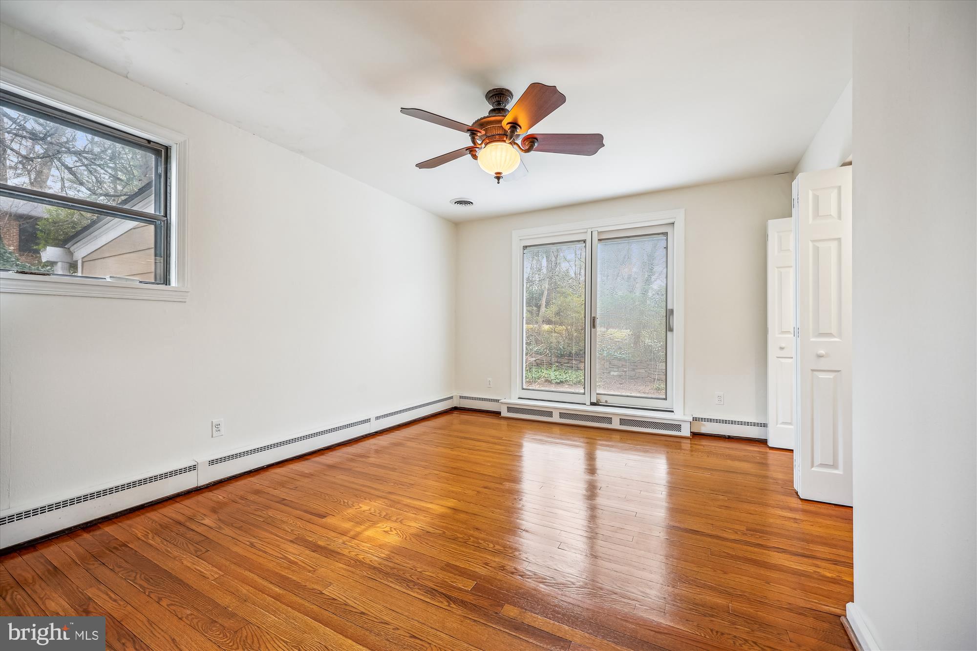 411 Pershing Drive Silver Spring, MD 20910 - Photo 31 of 64 a view of an empty room with window and wooden floor