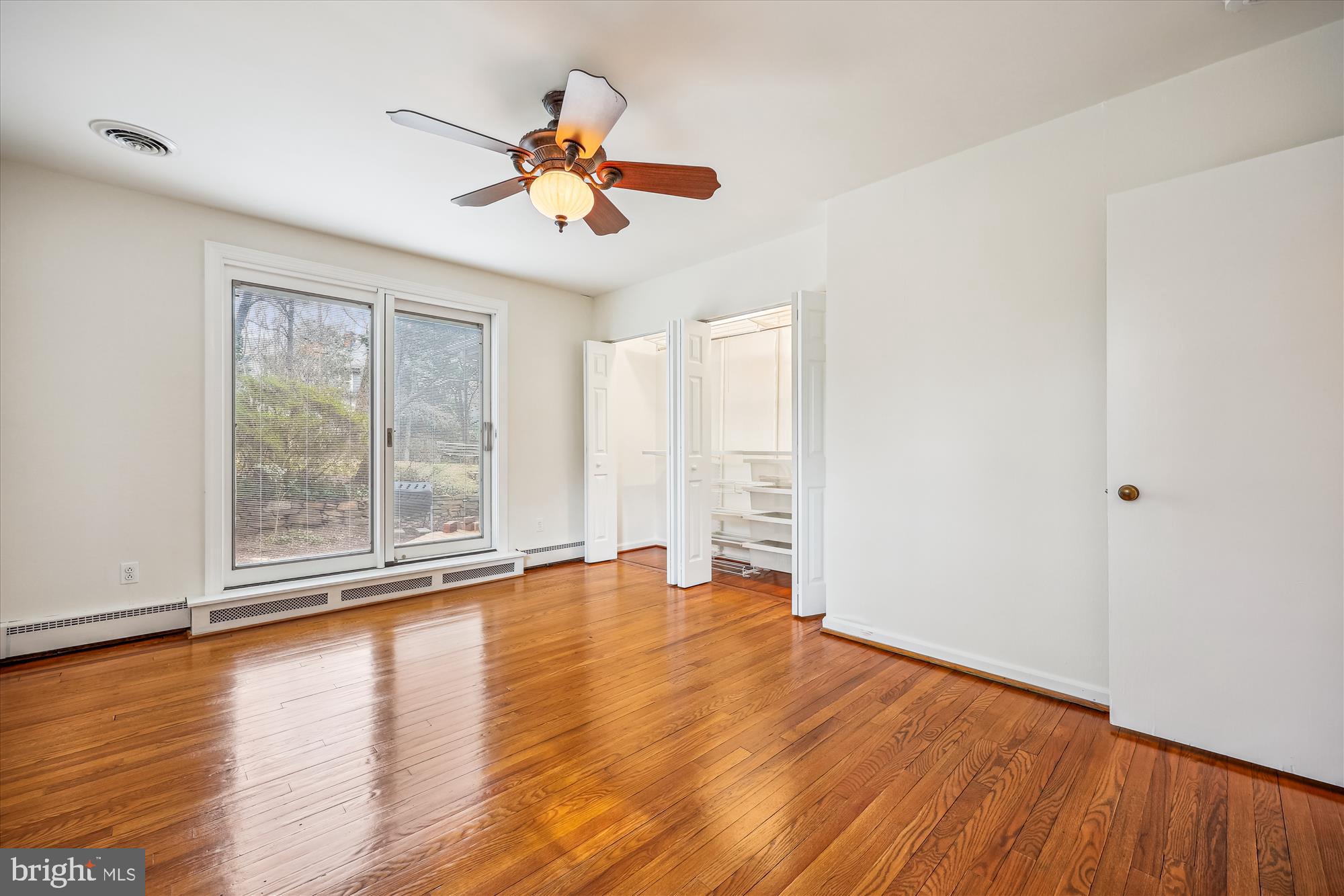 411 Pershing Drive Silver Spring, MD 20910 - Photo 33 of 64 a view of an empty room with wooden floor and a window