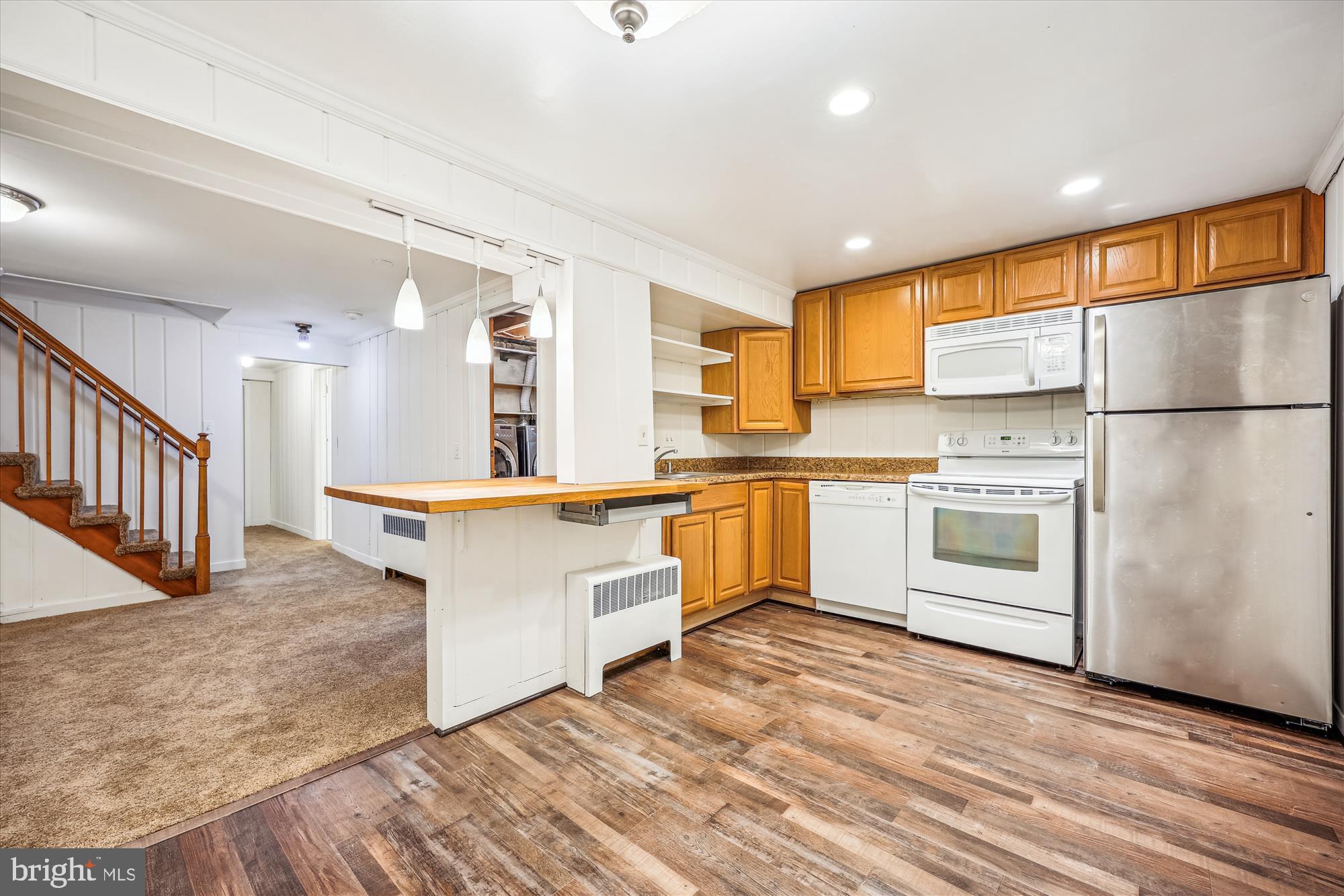411 Pershing Drive Silver Spring, MD 20910 - Photo 42 of 64 a kitchen with stainless steel appliances granite countertop a stove a sink and a refrigerator
