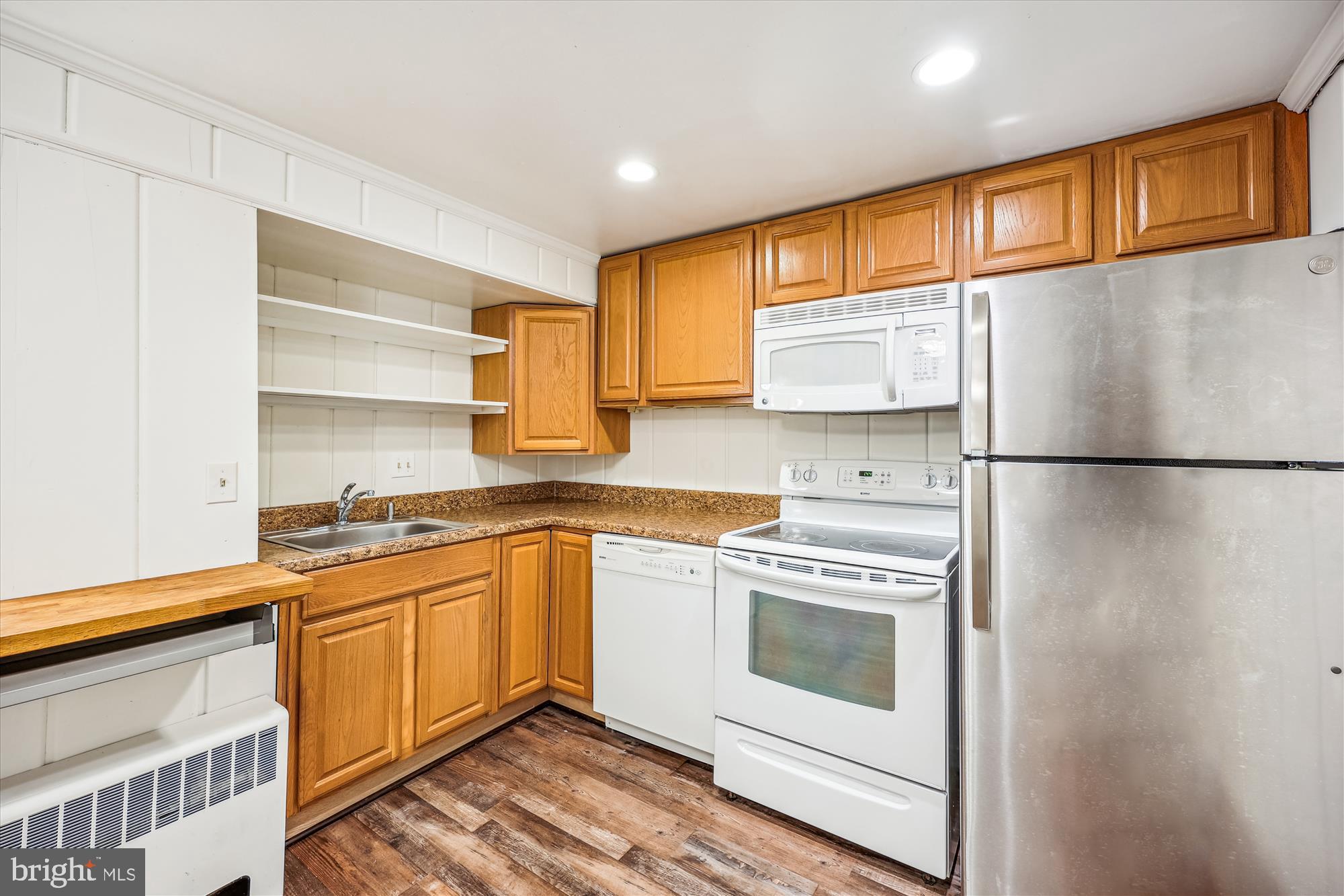 411 Pershing Drive Silver Spring, MD 20910 - Photo 44 of 64 a kitchen with stainless steel appliances granite countertop a refrigerator a sink dishwasher a stove and white countertops with wooden floor