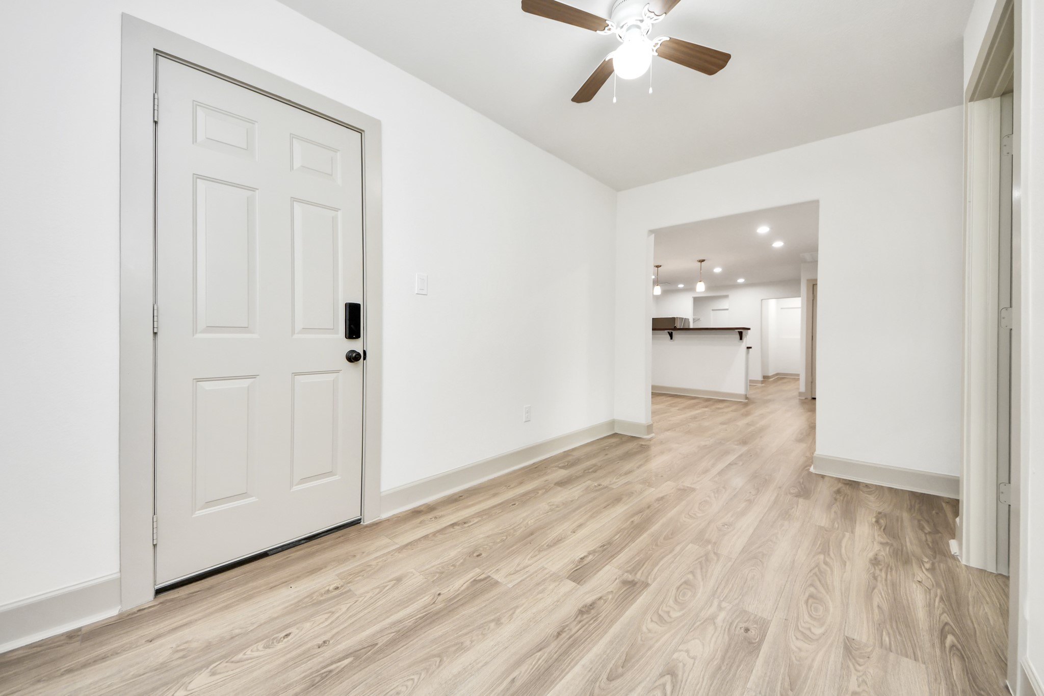 2919 Rosedale Street, Unit B Houston, TX 77004 - Photo 11 of 35 an empty room with wooden floor and windows