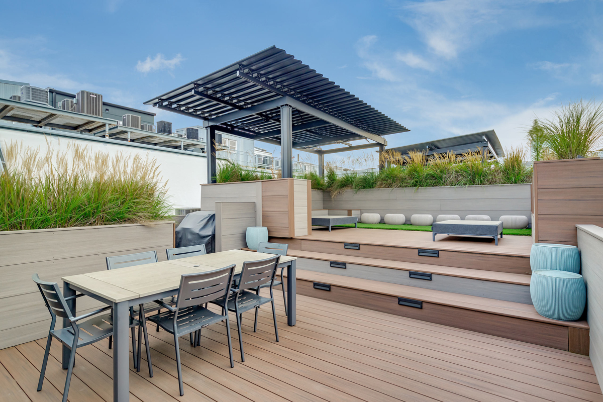 1000 West Washington Boulevard, Unit 331 Chicago, IL 60607 - Photo 5 of 5 a view of patio with table and chairs under an umbrella with a barbeque