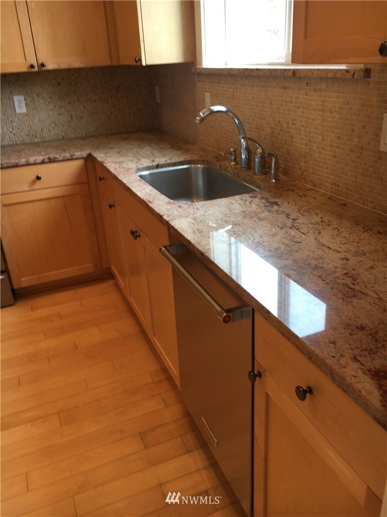 308 Northwest 89th Street Seattle, WA 98117 - Photo 2 of 9 a kitchen with a sink and cabinets