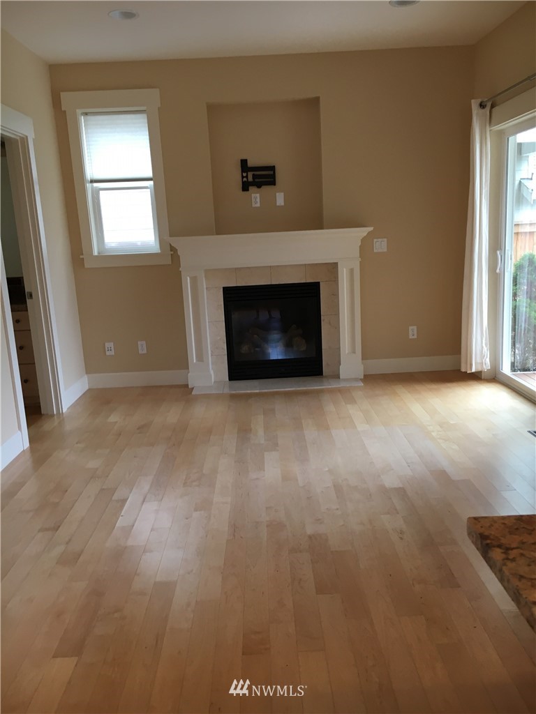 308 Northwest 89th Street Seattle, WA 98117 - Photo 6 of 9 a view of empty room with a fireplace