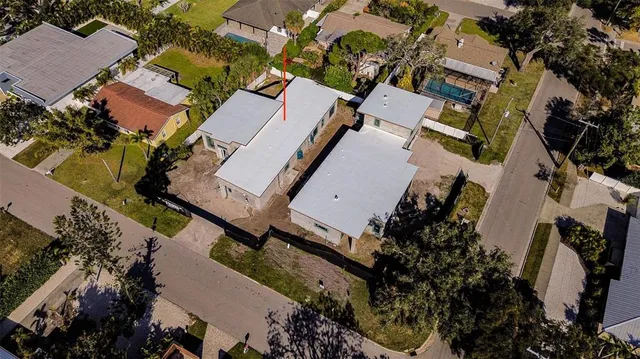 an aerial view of a house with yard and parking