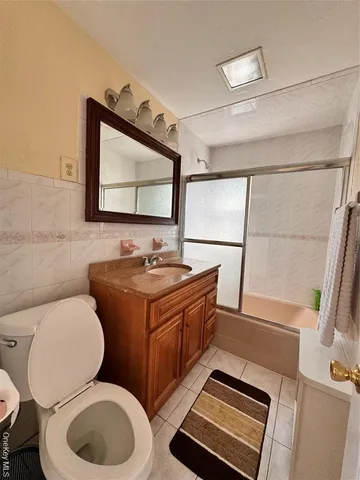a bathroom with a toilet a sink and a mirror