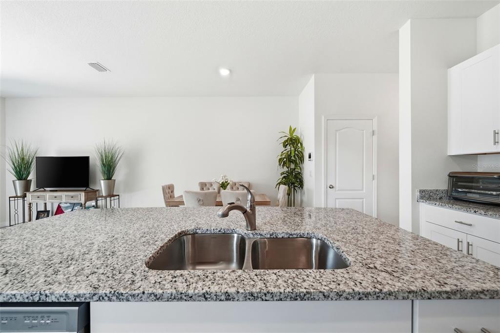 1503 Isleta Loop Kissimmee, FL 34741 - Photo 11 of 50 a kitchen with sink a microwave a stove and refrigerator