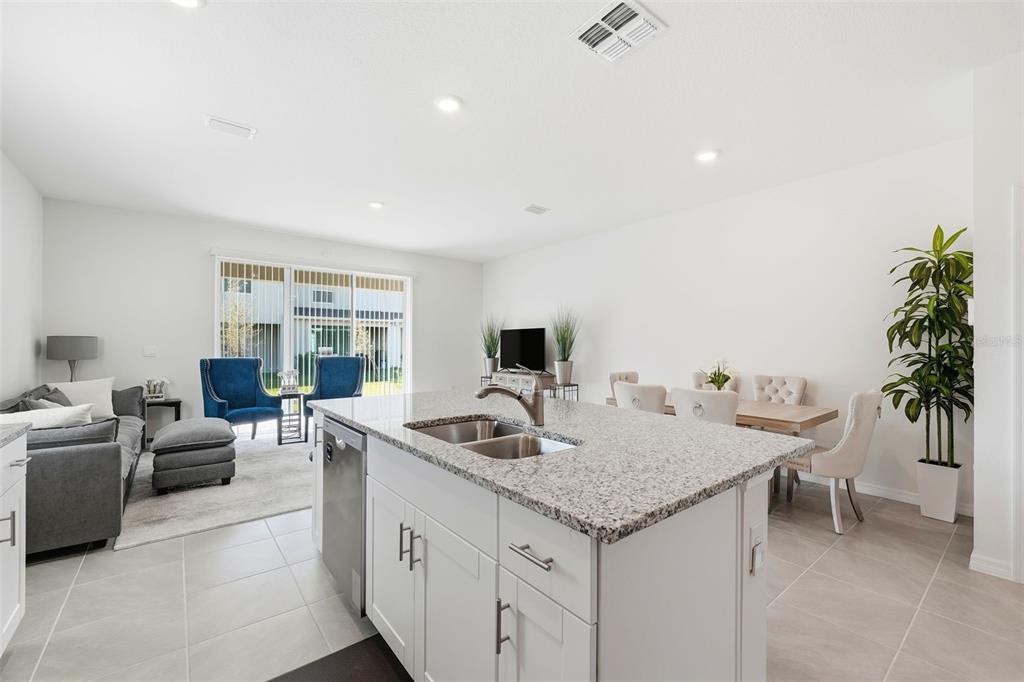 1503 Isleta Loop Kissimmee, FL 34741 - Photo 12 of 50 a kitchen with granite countertop a sink and a stove