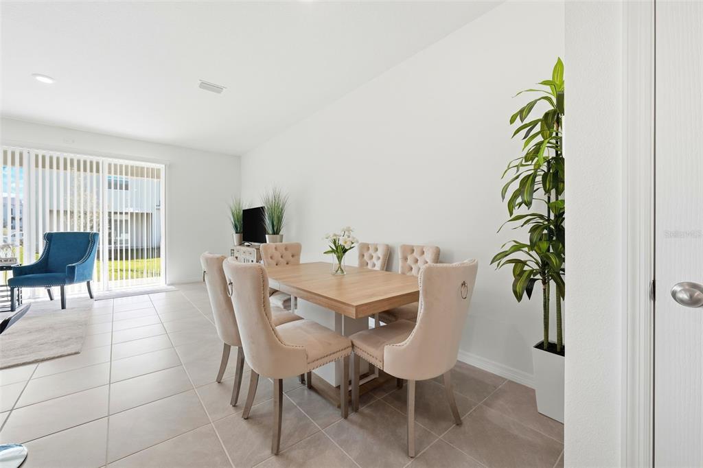 1503 Isleta Loop Kissimmee, FL 34741 - Photo 13 of 50 a view of a dining room with furniture and a potted plant