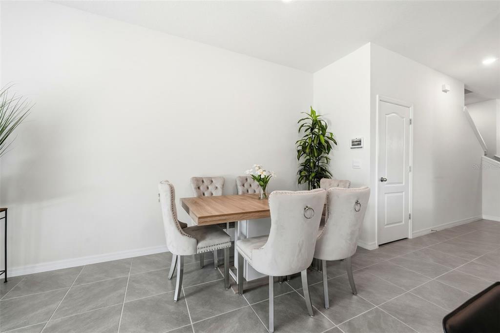 1503 Isleta Loop Kissimmee, FL 34741 - Photo 14 of 50 a view of a dining room with furniture and wooden floor