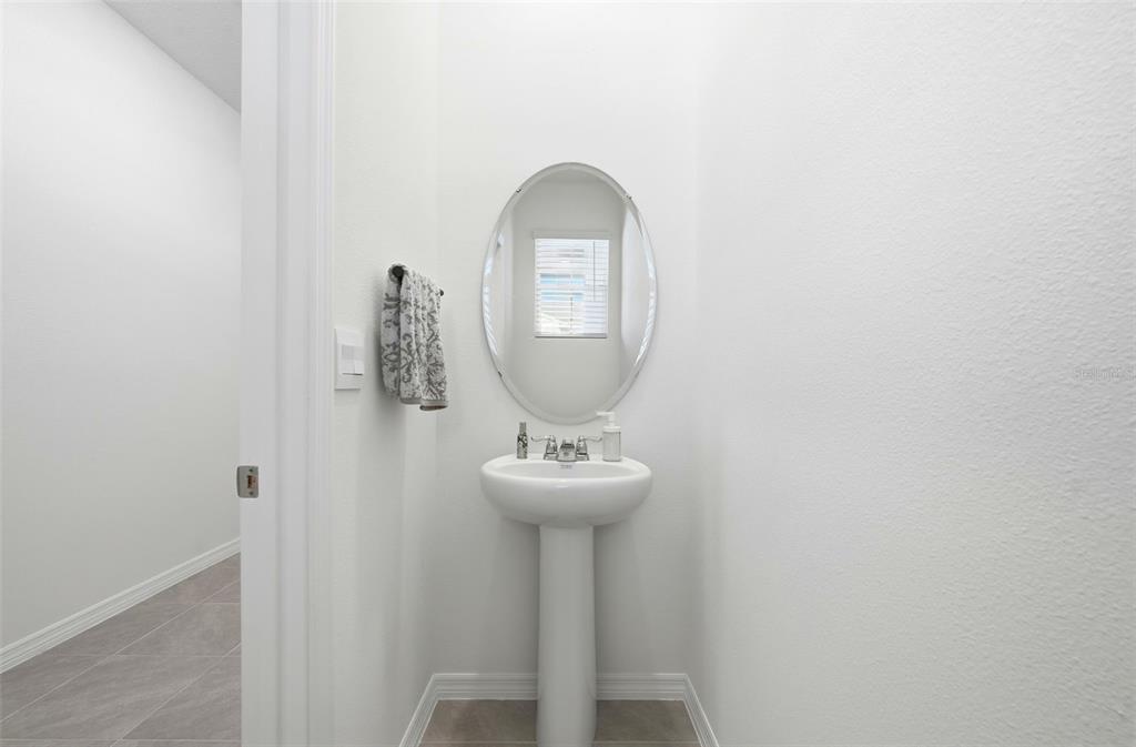 1503 Isleta Loop Kissimmee, FL 34741 - Photo 16 of 50 a bathroom with a sink and a mirror