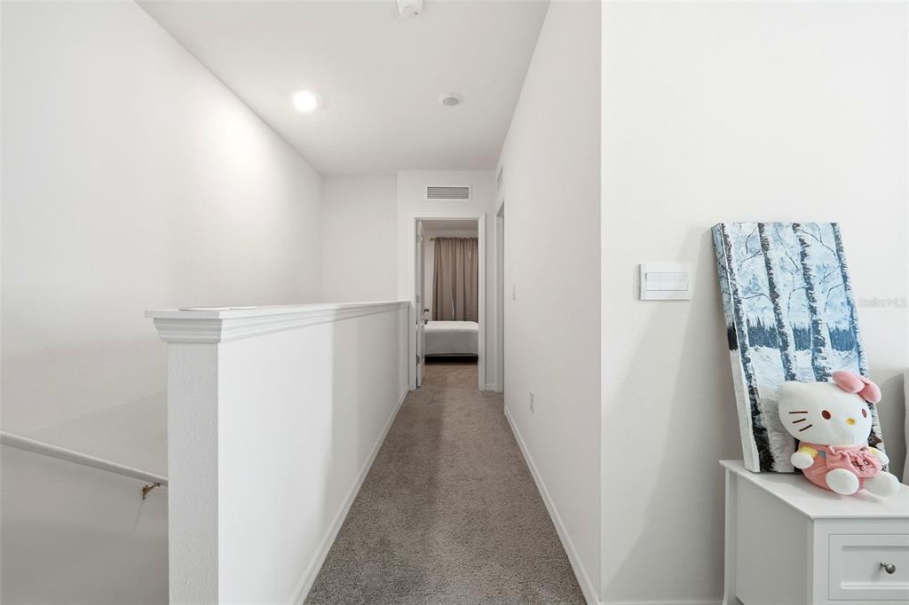 1503 Isleta Loop Kissimmee, FL 34741 - Photo 19 of 50 a view of a hallway with closet and wooden floor