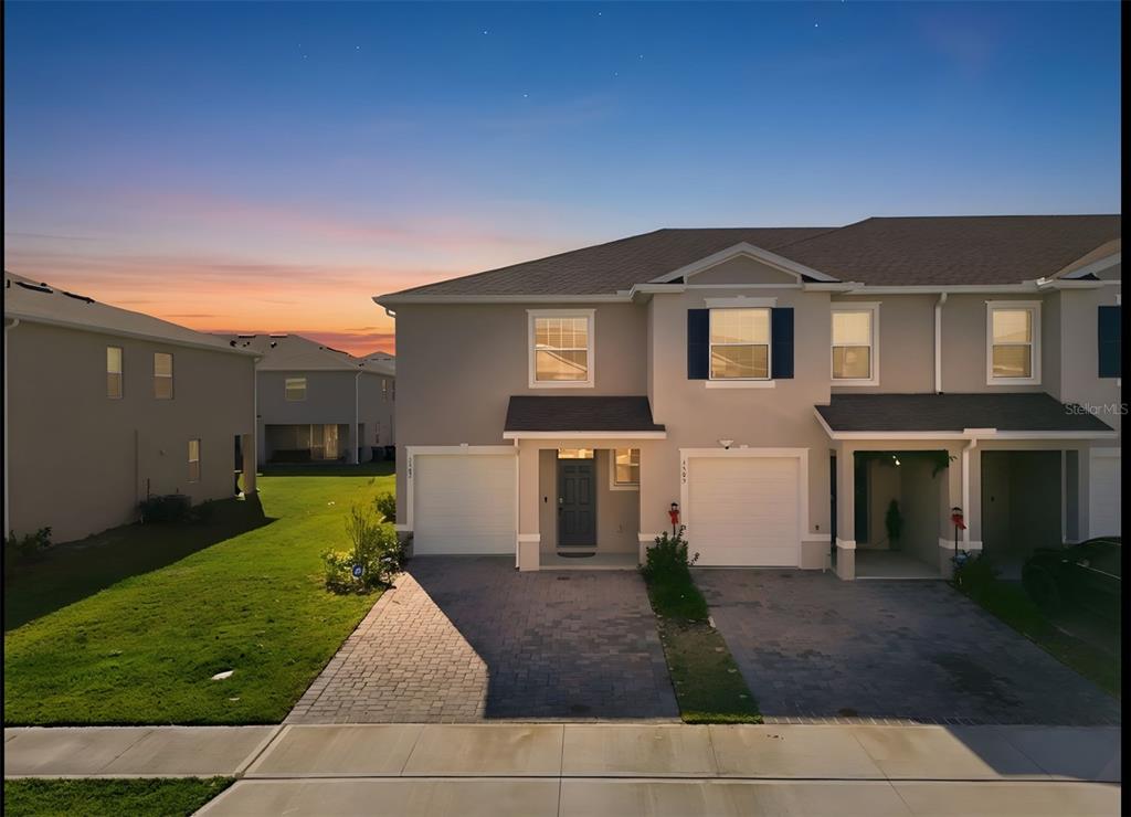 1503 Isleta Loop Kissimmee, FL 34741 - Photo 2 of 50 a front view of a house with a yard