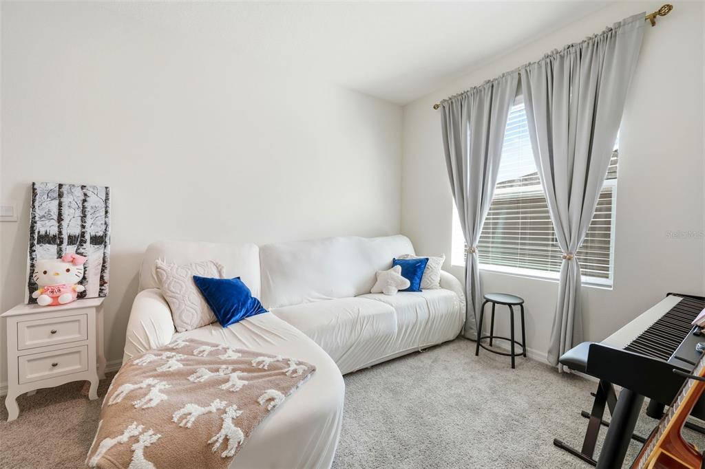 1503 Isleta Loop Kissimmee, FL 34741 - Photo 21 of 50 a bedroom with bed and a window