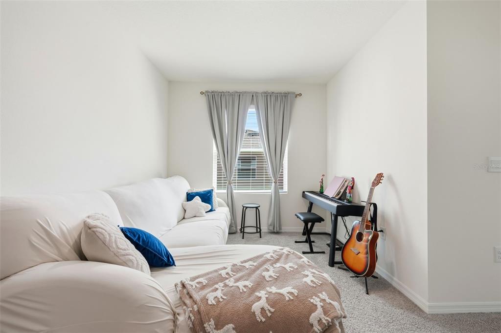 1503 Isleta Loop Kissimmee, FL 34741 - Photo 22 of 50 a bedroom with bed and a window