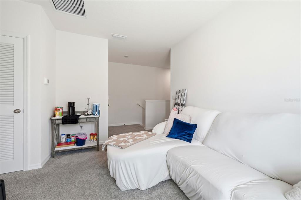 1503 Isleta Loop Kissimmee, FL 34741 - Photo 23 of 50 a bedroom with a bed and a desk