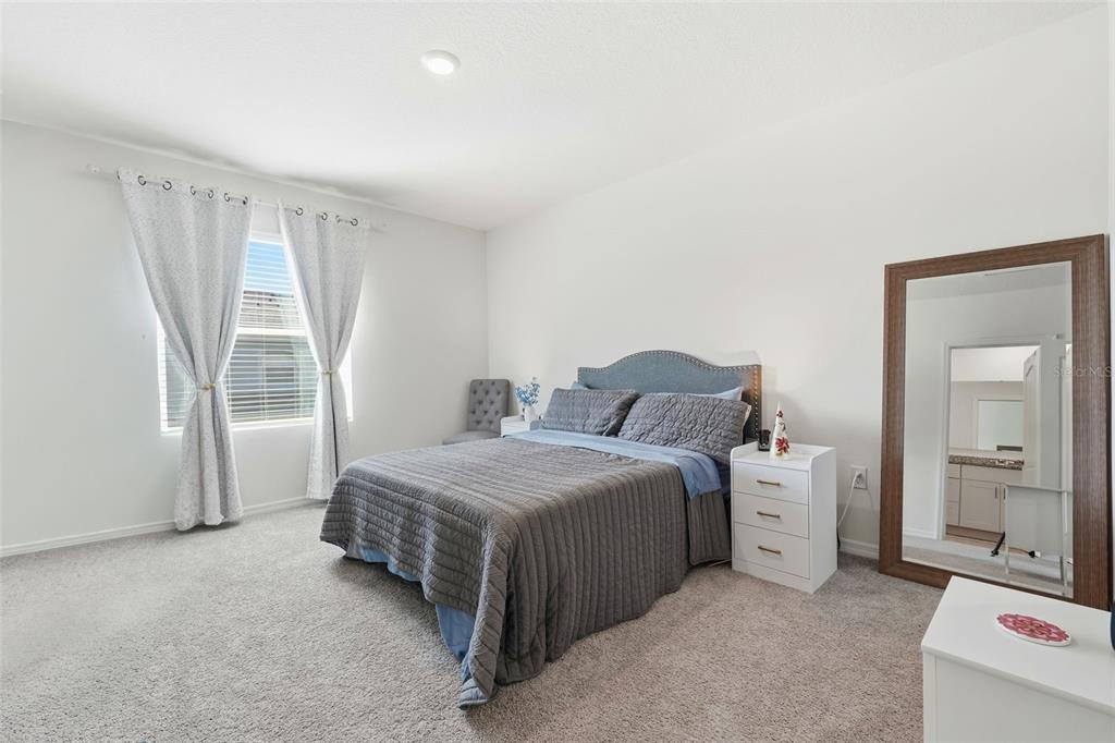 1503 Isleta Loop Kissimmee, FL 34741 - Photo 24 of 50 a bedroom with a bed and a window