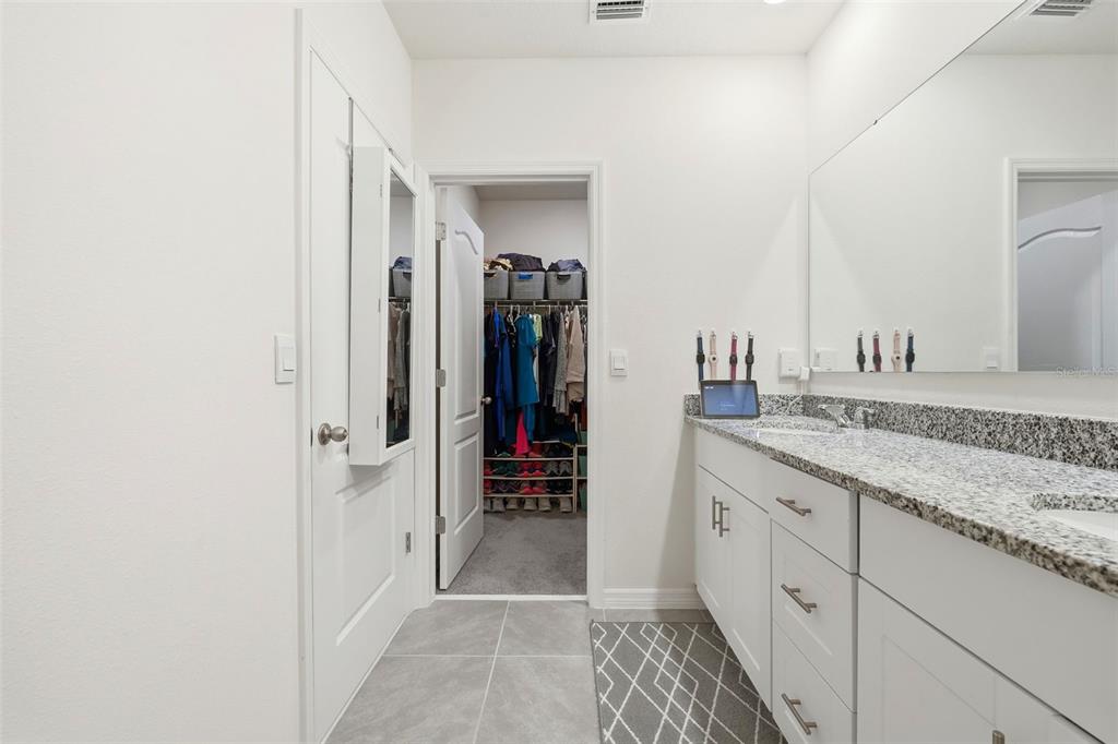 1503 Isleta Loop Kissimmee, FL 34741 - Photo 26 of 50 a bathroom with a granite countertop sink and a mirror