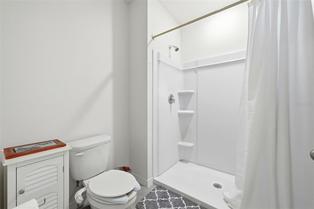 1503 Isleta Loop Kissimmee, FL 34741 - Photo 28 of 50 a bathroom with a toilet and a shower