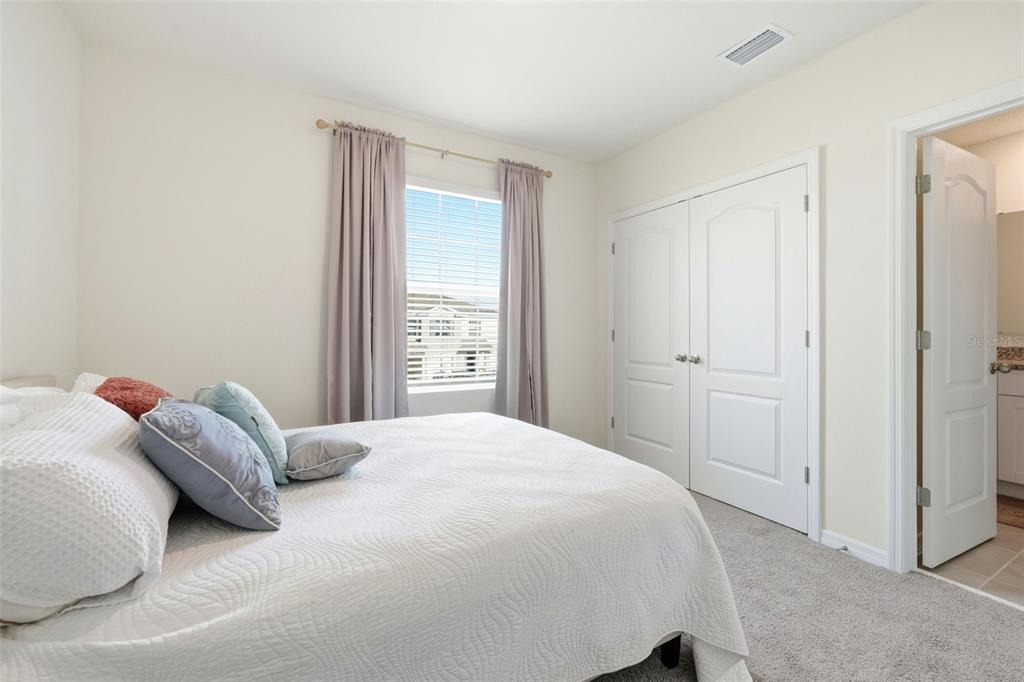 1503 Isleta Loop Kissimmee, FL 34741 - Photo 30 of 50 a bedroom with a bed and a window