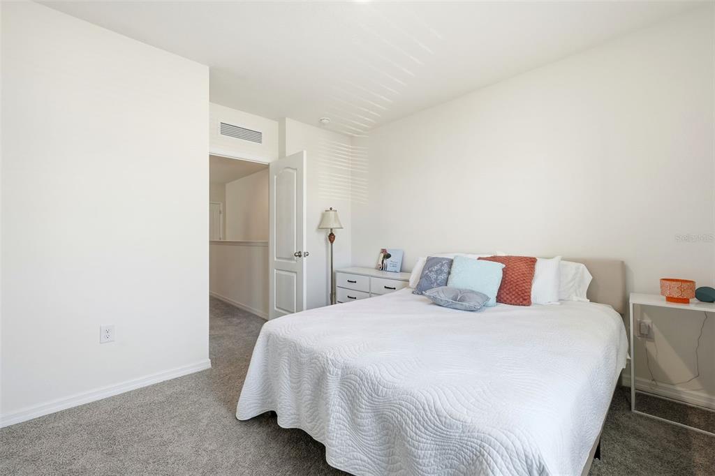 1503 Isleta Loop Kissimmee, FL 34741 - Photo 31 of 50 a bedroom with a bed and a night stand