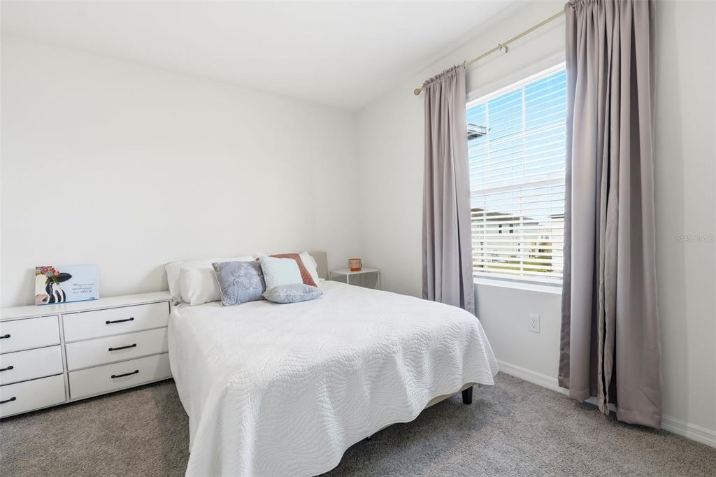 1503 Isleta Loop Kissimmee, FL 34741 - Photo 32 of 50 a bedroom with a bed and a window