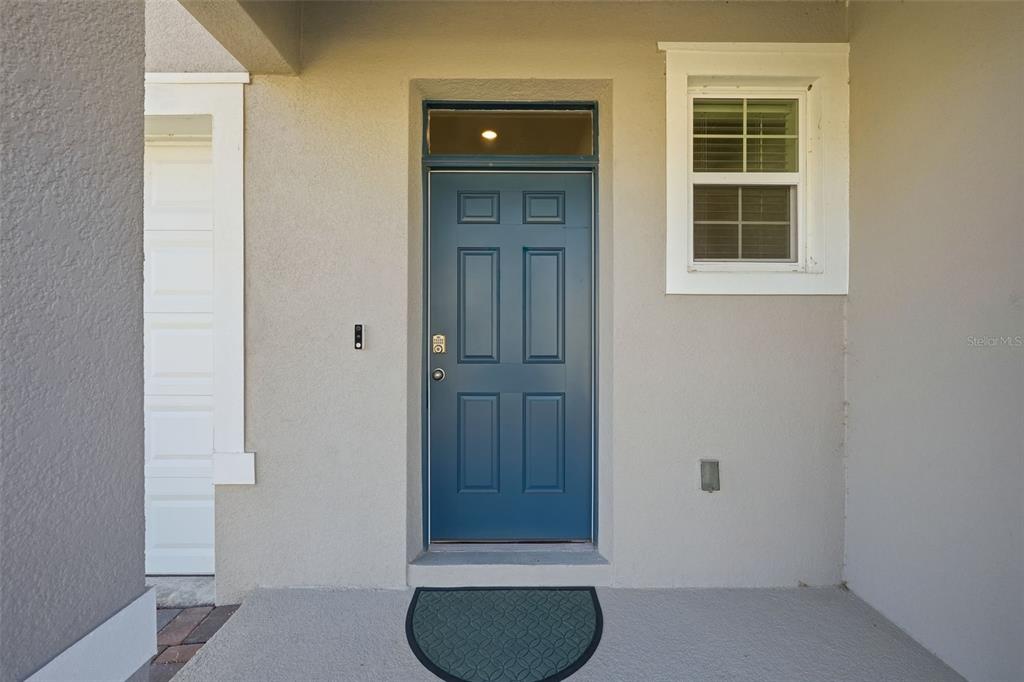 1503 Isleta Loop Kissimmee, FL 34741 - Photo 4 of 50 an entryway with wooden floor and cabinet