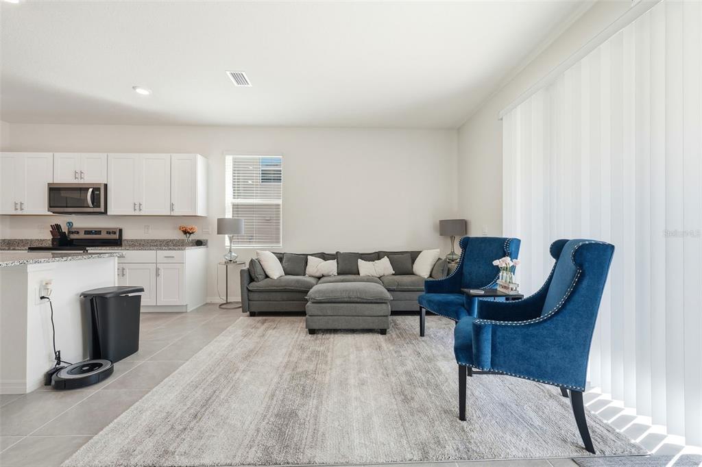 1503 Isleta Loop Kissimmee, FL 34741 - Photo 8 of 50 a living room with furniture a fireplace and a flat screen tv