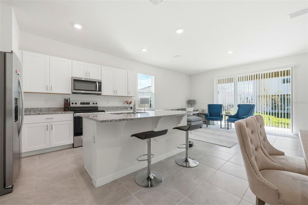 1503 Isleta Loop Kissimmee, FL 34741 - Photo 9 of 50 a kitchen with counter top space cabinets and appliances