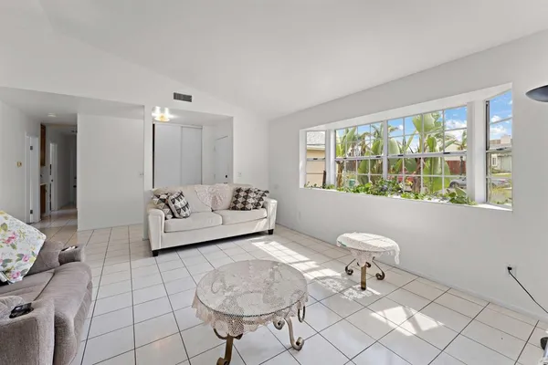 a living room with furniture and a floor to ceiling window