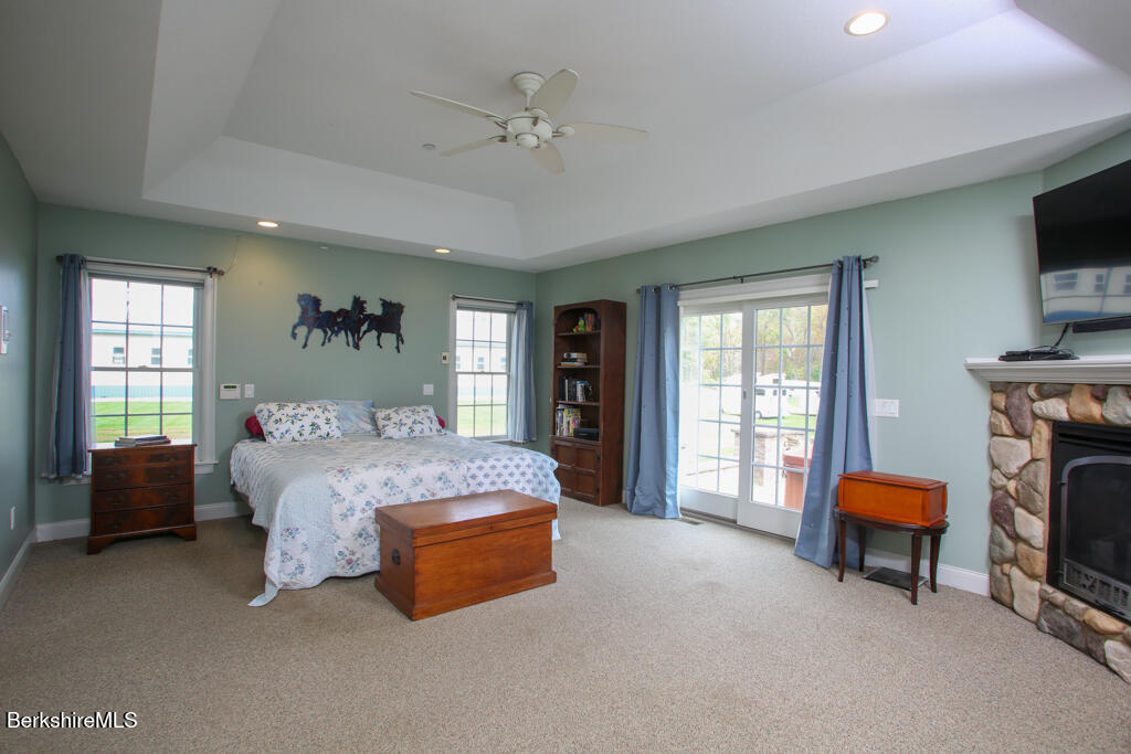200 Easthampton Road Westhampton, MA 01027 - Photo 13 of 69 a spacious bedroom with a bed and a chandelier