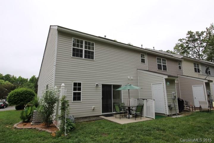 8304 Rudolph Road, Unit 8304 Charlotte, NC 28216 - Photo 3 of 20 a view of a white house with a yard and table and chairs