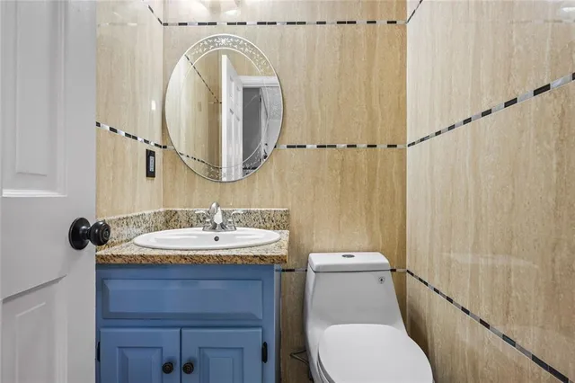 a bathroom with a sink a toilet and a mirror