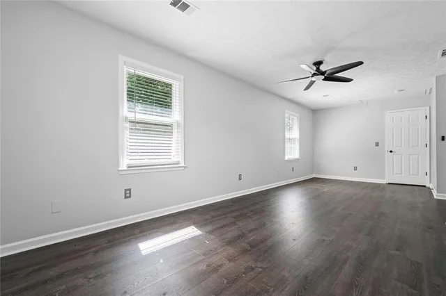 wooden floor in an empty room with a window