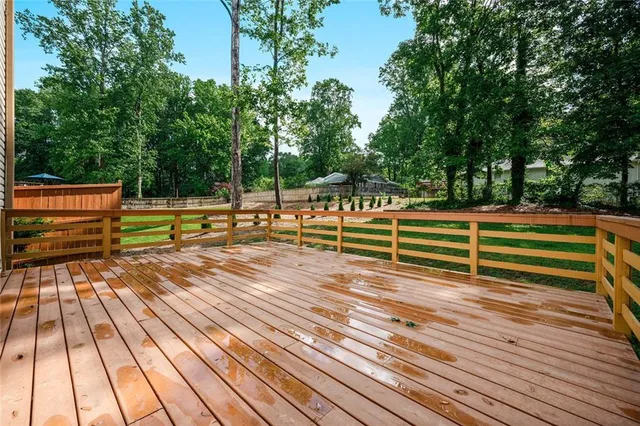 a view of outdoor space with deck and trees