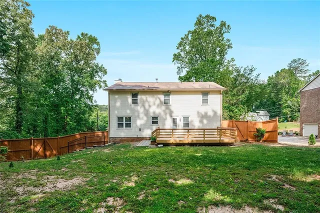 an outdoor sitting area with a bench and trees