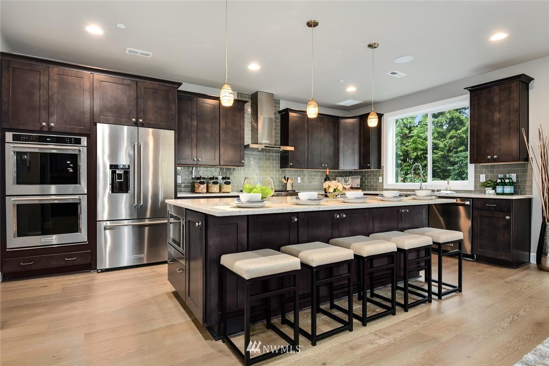 20405 4th Drive Southeast Bothell, WA 98012 - Photo 13 of 31 a kitchen with a table chairs refrigerator and cabinets