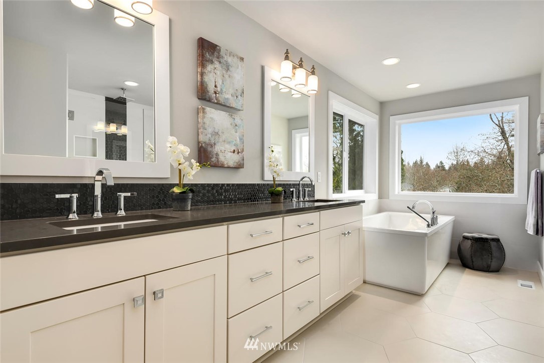 20405 4th Drive Southeast Bothell, WA 98012 - Photo 28 of 31 a spacious bathroom with a double vanity sink a large mirror and a bathtub