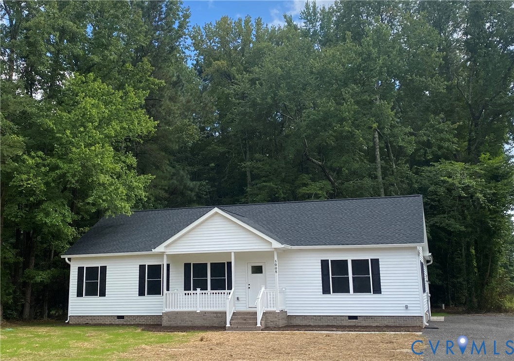 a white house with a large pool in front of it