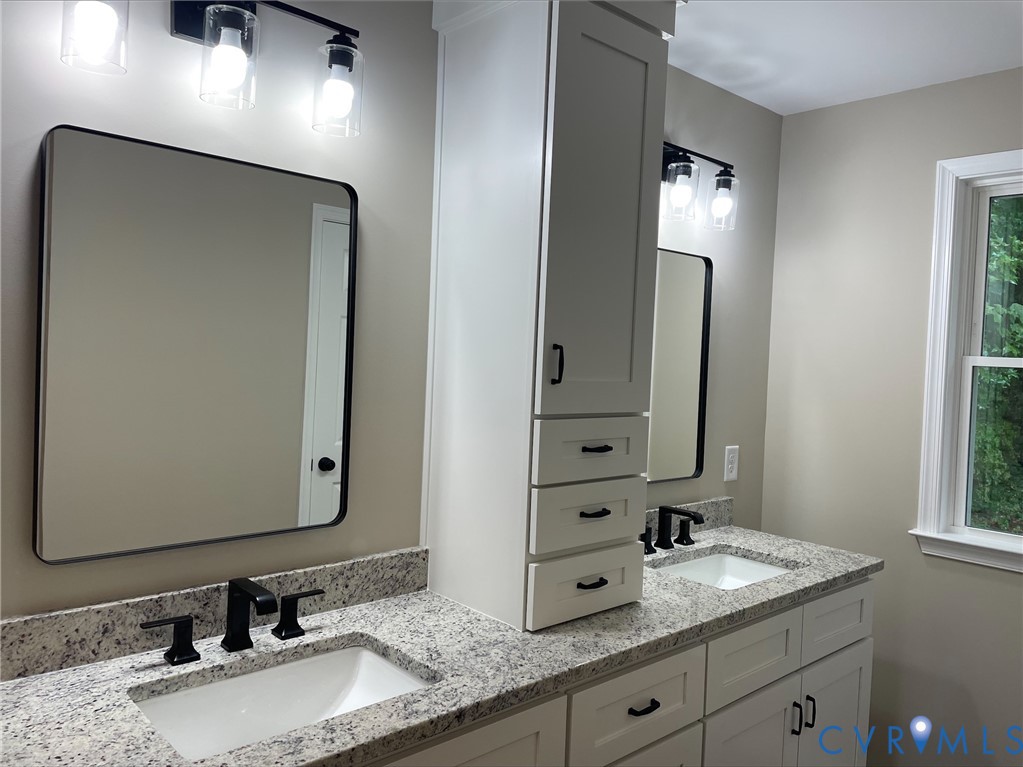 5008 Chestnut Fork Road Gloucester, VA 23061 - Photo 17 of 35 a bathroom with a granite countertop double vanity sink and a mirror