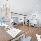 a living room with furniture a rug and a chandelier