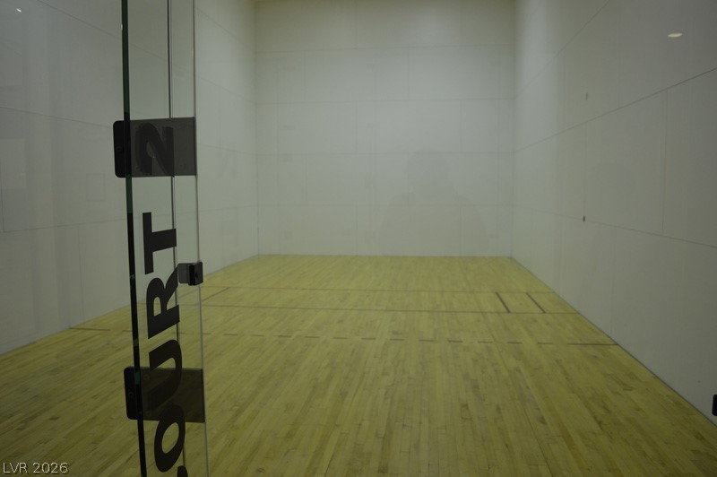 87 Tall Ruff Drive Las Vegas, NV 89148 - Photo 23 of 71 A well-maintained indoor court awaits intense matches with pristine hardwood flooring.