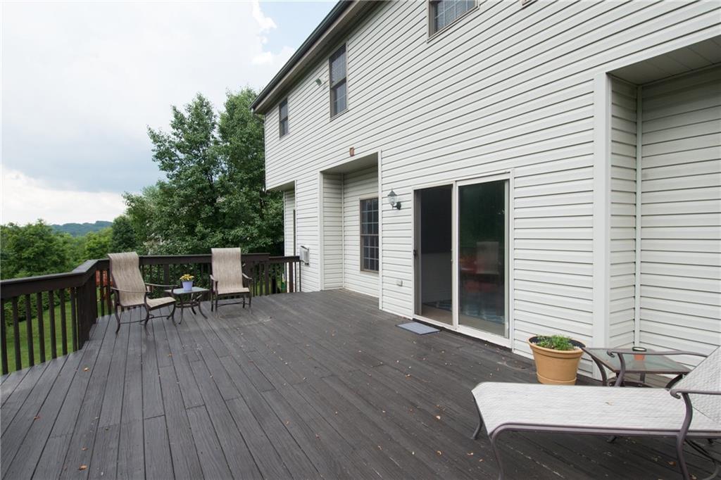 190 Warren Road Warrendale, PA 15086 - Photo 24 of 25 The expansive deck is located directly off the kitchen. It overlooks the private yard and mature trees that allow for privacy and create a serene setting for entertaining and relaxing.