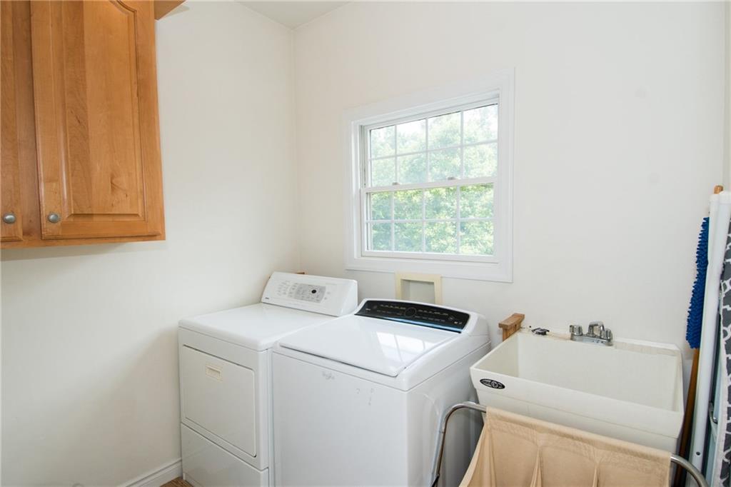 190 Warren Road Warrendale, PA 15086 - Photo 8 of 25 A large laundry room with utility sink, storage, ample additional space and a window to bring in natural light---this is a fantastic laundry room and the location is so convenient right off of the kitchen!