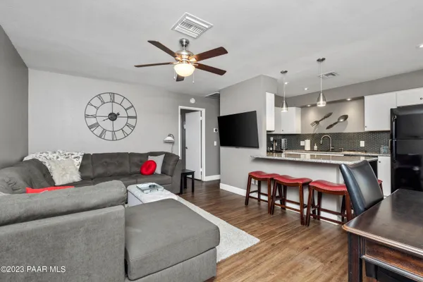 a living room with furniture and a wooden floor