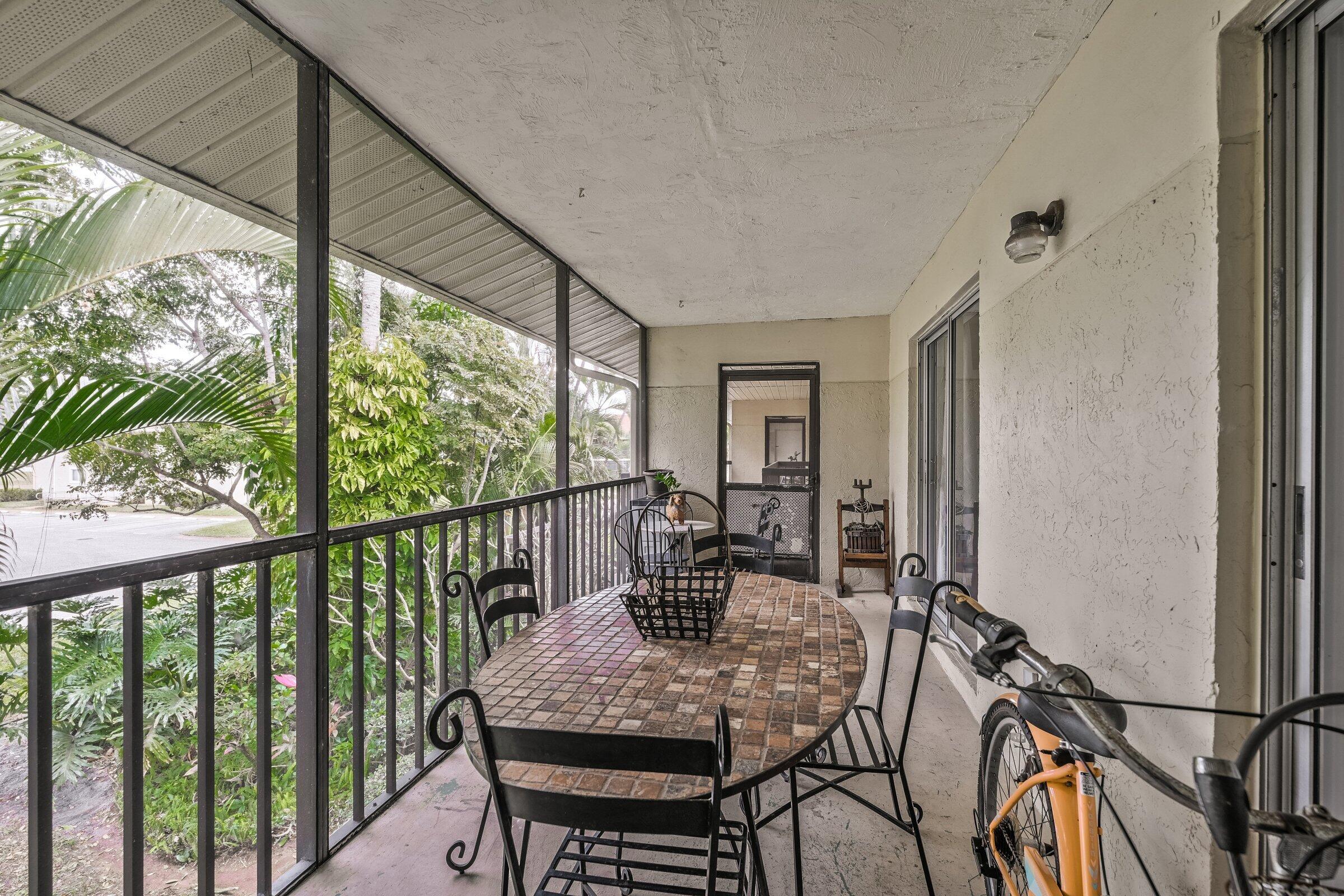 6544 Chasewood Drive, Unit H Jupiter, FL 33458 - Photo 3 of 14 a view of a dining room with furniture window and outside view