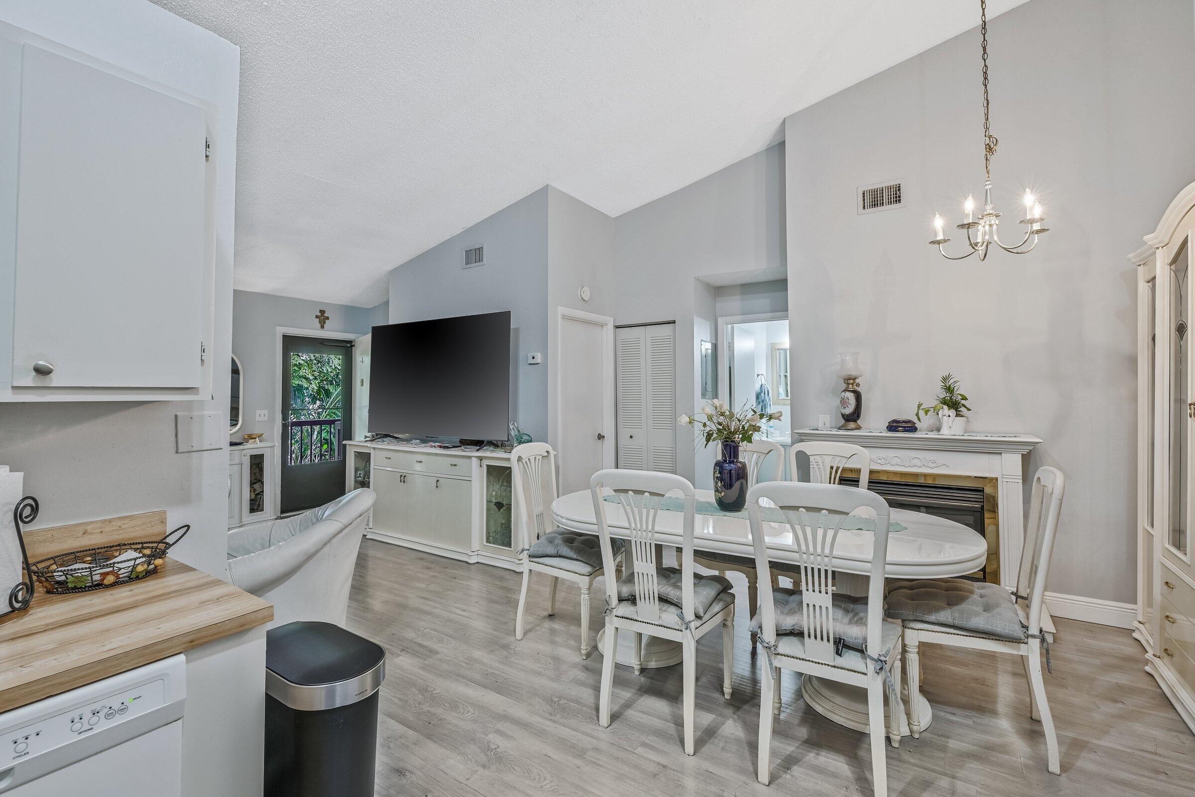 6544 Chasewood Drive, Unit H Jupiter, FL 33458 - Photo 9 of 14 a view of a dining room with furniture window and wooden floor