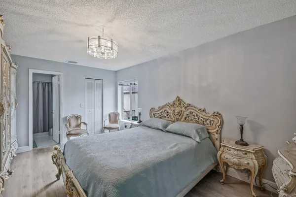 a bedroom with a bed and a chandelier